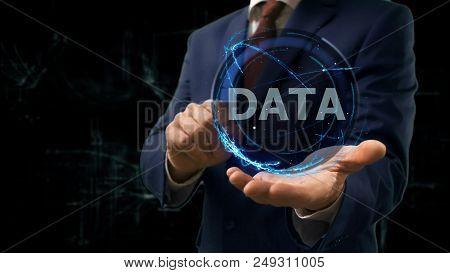 Businessman Shows Concept Hologram Data On His Hand. Man In Business Suit With Future Technology Scr