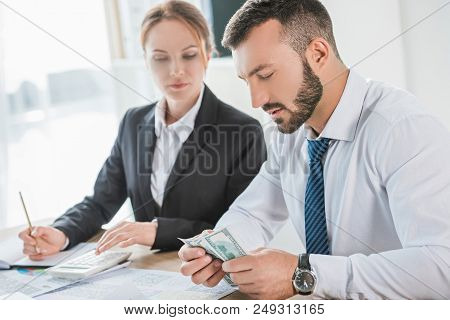 Iew Of Accountants Counting Dollar Banknotes In Office