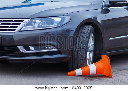A Breakdown Trianle Is Standing Near A Grey Car That Got In A Harsh Accident On The Road.