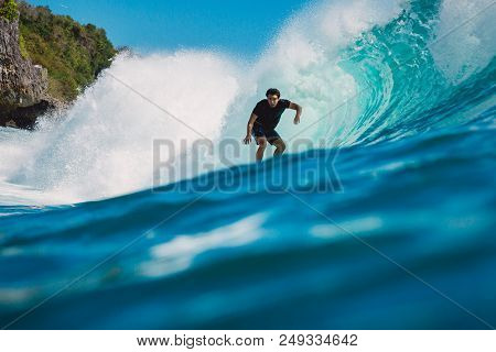 July 7, 2018. Bali, Indonesia. Surfer Ride On Big Barrel Wave At Padang Padang. Professional Surfing