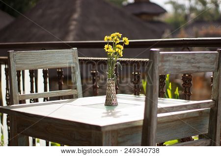 Wooden Furniture In A Cafe On Sunside Patio In Ubud