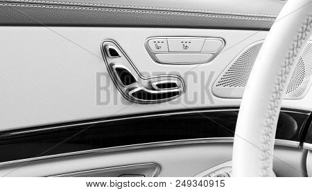 Door Handle With Power Seat Contol Buttons Of A Luxury Passenger Car. White Leather Interior Of The 