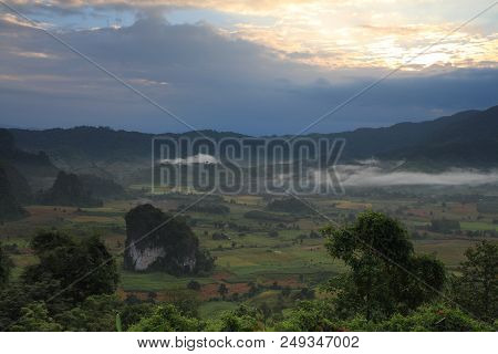 Rock Mountain Protruding From Rice Field. Morning Fog On Sunrise In The Phulanka, Phayao Thailand.
