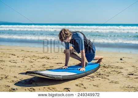 Young Man Surfer Training Before Go To Lineup On A Sand Beach. Learning To Surf. Vacation Concept. S