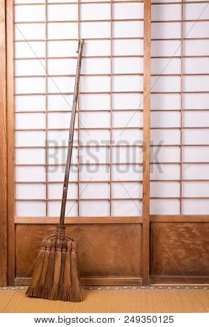 Broom Made From Chusan Palm Which Lean On Paper Sliding Door In Vertical Composition