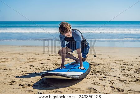 Young Man Surfer Training Before Go To Lineup On A Sand Beach. Learning To Surf. Vacation Concept. S