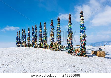 Wooden Ritual Pillars With Colorful Ribbons On Cape Burkhan, Lake Baikal, Olkhon Island, Siberia, Ru