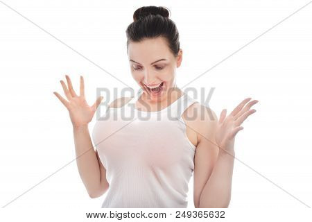 Young Woman Shows Her Big Fake Breasts On White Background Looking At Camera Smiling