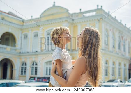 Mom And Son On Background Of Old Town Hall In George Town In Penang, Malaysia. The Foundation Stone 