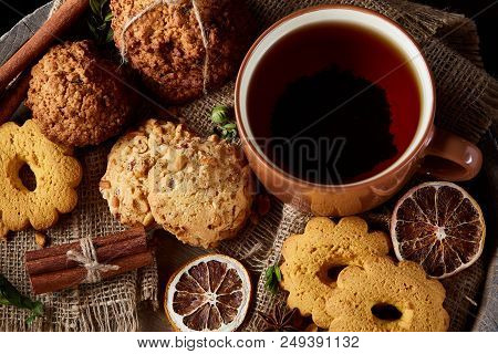 Cookies With Cinnamon And Two Cups Of Tea On A Burlap Napkin, Selective Focus, Close-up, Top View. D