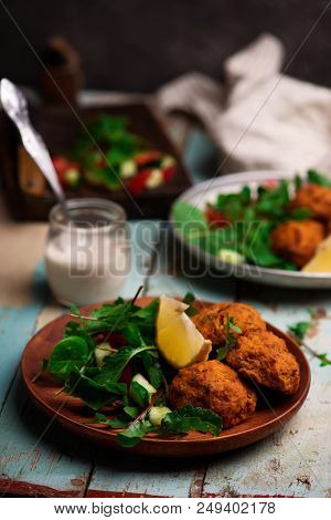 Beet Falafel With Tahina  Sauce And Green . Salad Selective Focus