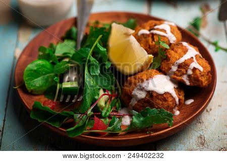Beet Falafel With Tahina  Sauce And Green . Salad Selective Focus