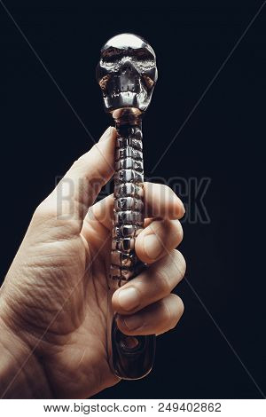 Kickstarter Pedal For A Motorcycle With A Skull On A Black Background With Hand