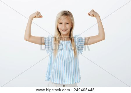 Someday Girl Become Famous Sportswoman. Little Confident Kid With Blond Hair In Blue Blouse, Raising