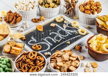 Variation Different Unhealthy Snacks Crackers, Sweet Salted Popcorn, Tortillas, Nuts, Straws, Bretse