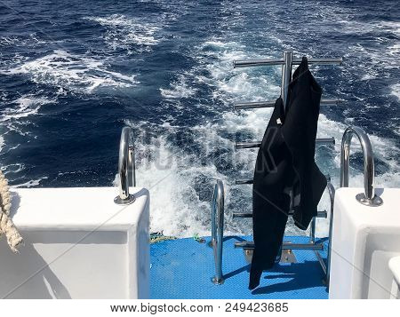 Black Waterproof Wetsuit For Diving, Swimming Hangs On The Cto Descend Into The Blue Water, The Sea 