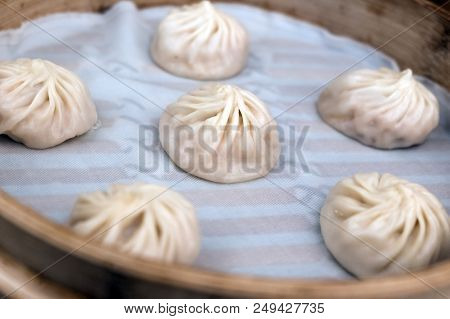China Steamed Bun Or Xiaolongbao In Small Bamboo Basket.