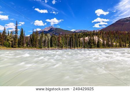 Rapidly Moving Waters Of Athabasca River Flowing Toward Athabasca Falls In Jasper National Park In A