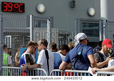 ST. PETERSBURG, RUSSIA - JULY 14, 2018: Football fans under intense heat at Saint-Petersburg stadium before the match for 3rd place of FIFA World Cup Russia 2018 England vs Belgium. Belgium won 2-0