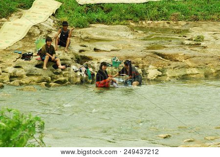 Yogyakarta - Indonesia. December 28, 2011. Women Washing Clothes At The River At Sokoliman, Gunungki