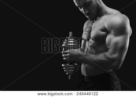 Athletic Young Man With Dumbbell On Black Background, Making Strenth Biceps Exercises. Naked Torso, 
