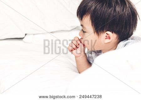 Little Baby Sucking Thumb On A Bed