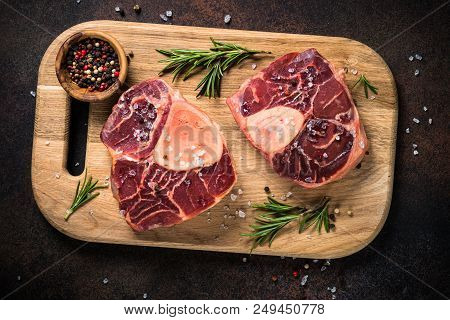 Raw Beef Steak Osso Bucco With Spices And Herbs. Ready To Cooking. View From Above Close Up.