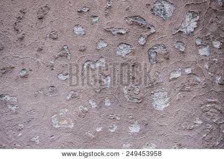 Wallpaper Texture Of Worn Concrete Wall Colored In Salmon Paint With Decayed Peeling Plater. No Peop