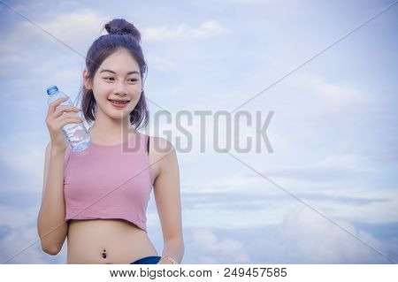 Healthy Girl's Drinking Water In The Bottle , Drink For Thirstily For Refreshing