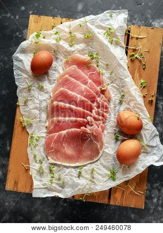 Butchers Made Free Range Raw Lean Unsmoked Bacon Pork Medallions And Hen Eggs On Wooden Box.