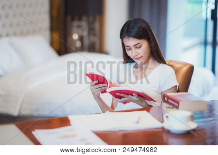 Asian Lady Student Read A Text Book For Prepare To Examination On The Bedroom, This Immage Can Use F