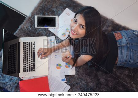 University Student Sit And Do Home Work In Computer Notebook On The Floor In Bed Room, This Immage C