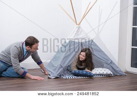 Father And Daughter Playing At Home