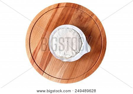 Cottage Cheese In Plastic Packaging Lying On The Wooden Board . Isolated On White Background. Curd -