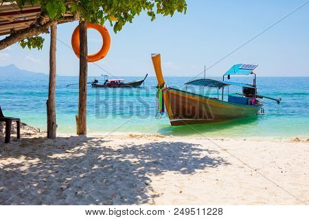 Traditional Longtail Boat Moored At Aonang Beach On Sunny Day
