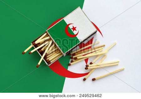 Algeria Flag  Is Shown On An Open Matchbox, From Which Several Matches Fall And Lies On A Large Flag