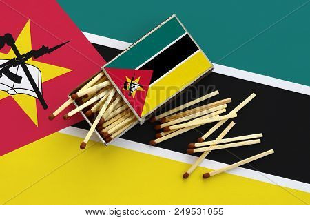 Mozambique Flag  Is Shown On An Open Matchbox, From Which Several Matches Fall And Lies On A Large F