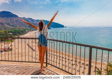 Young Tourist Woman On The Beach And Sea Landscape With Sperlonga, Lazio, Italy. Scenic Resort Town 