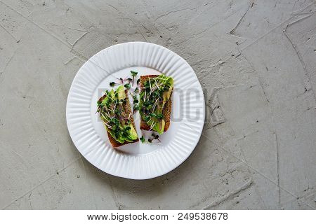 Balanced Vegan Breakfast Or Lunch Flat-lay. Avocado Toasts On Plate With Micro Greens Over Light Con