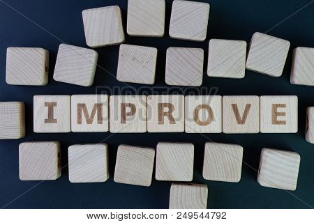 Self Or Personal Improvement Concept By Cube Wooden Block With Alphabet Building The Word Improve At