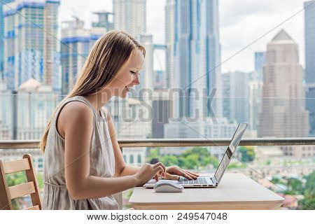 Young Woman Teaches A Foreign Language Or Learns A Foreign Language On The Internet On Her Balcony A