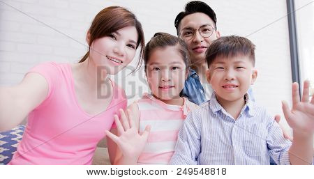Family Take A Selfie And Video By Phone At Home