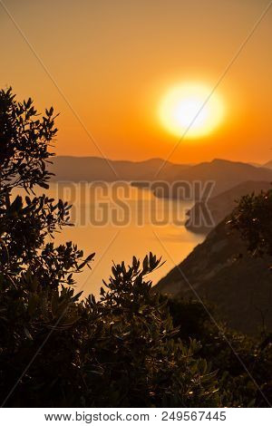 Aerial Sunrise Behind Alonisos Island From The Top Of A Hill In Skopelos, Greece