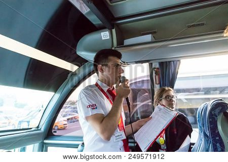 Marmaris, Turkey - May 19, 2018: Male Tour Guide With A Microphone In The Bus In Evening Time