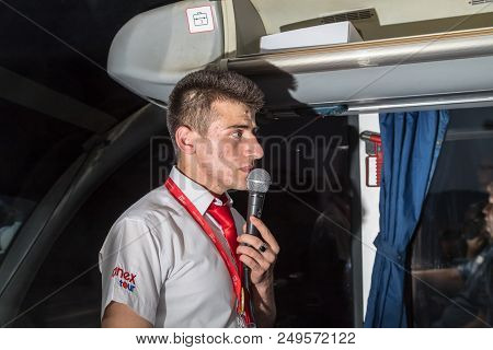 Marmaris, Turkey - May 19, 2018: Male Tour Guide With A Microphone In The Bus In Evening Time