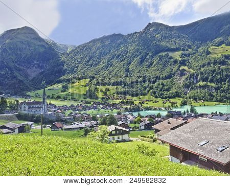 Beautiful Summer Day View From Train Window Of Lungern Village And Lake Lungern, Obwalden Canton, Sw
