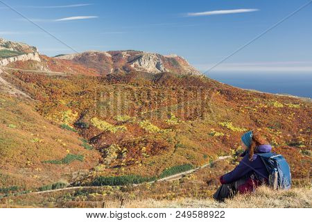 The Tourist Looks At The Demerdzhi Mountains, The Autumn Forest And The Road From Simferopol To Alus