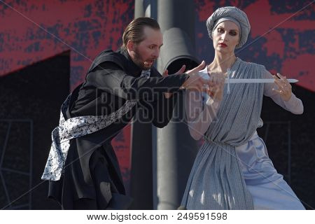 ST. PETERSBURG, RUSSIA - JULY 15, 2018: Dmitry Kondratiev as Macbeth (left) in the opera Macbeth outdoors during the festival All Together Opera. It was 2nd of 4 performances