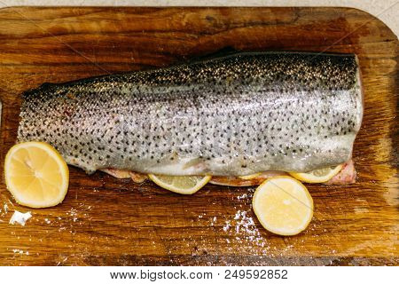 Raw Fish. Raw Fresh Salmon, Trout, On A Table On A Cutting Board. Kitchen. With Lemon Ready For Baki