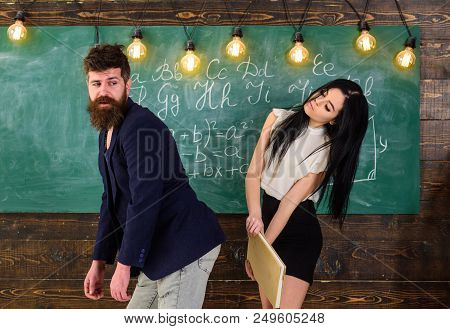 Student Lady Slapping On Teachers Buttocks With Book. Girl On Smiling Face Having Fun While Punishes
